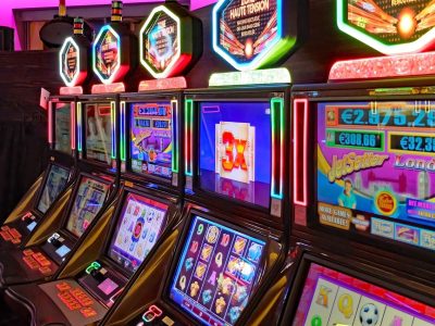 Real casino slots machine with spinning reels and bonus feature symbols on a bright screen